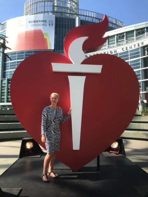 Leonie in front of heart and torch at Scientific Sessions